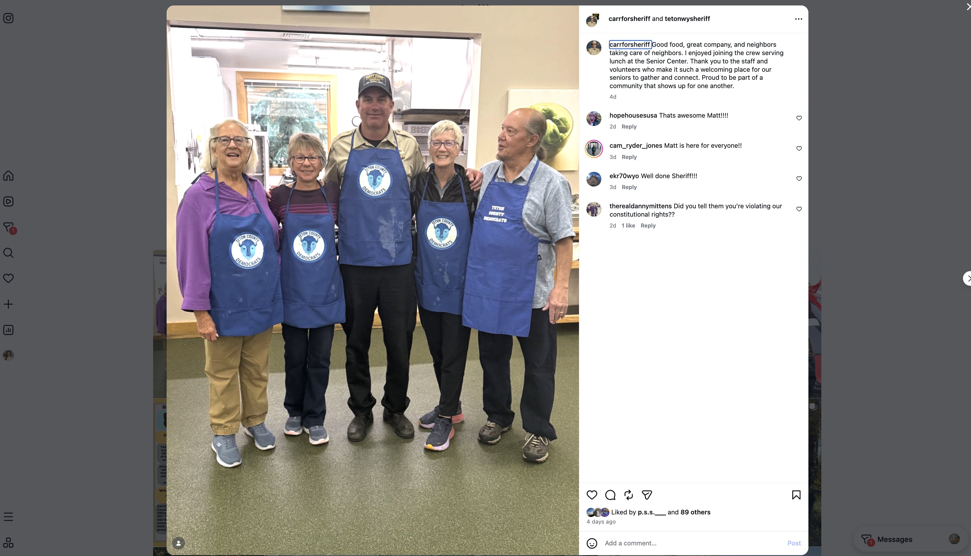 An Instagram collaboration post by carrforsheriff and tetonwysheriff: Carr in a Sheriff's Office uniform shirt and a Matt Carr Sheriff campaign cap, wearing a Teton County Democrats apron, with four volunteers in Teton County Democrats aprons in the Senior Center kitchen.
