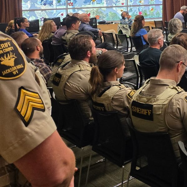 Thumbnail of Exhibit I, a sergeant's sleeve and seated deputies at the forum.