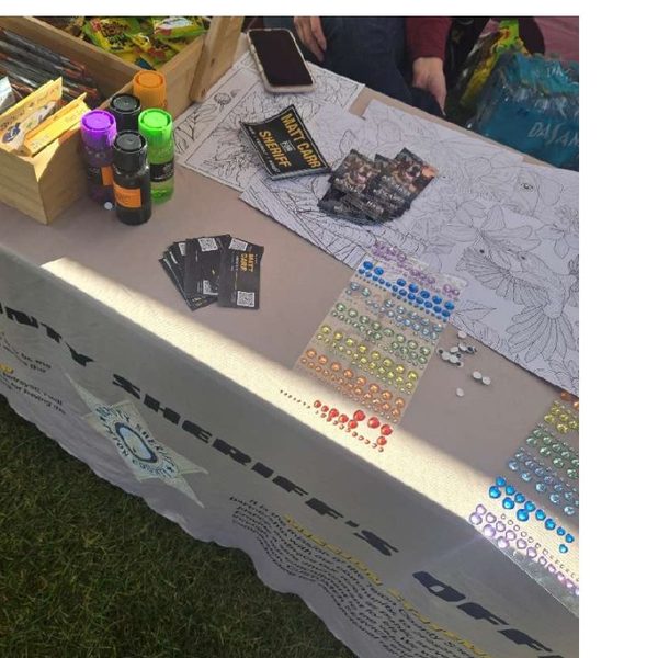 Thumbnail of Exhibit O, campaign materials on the Sheriff's Office table at Old Bill's Fun Run.